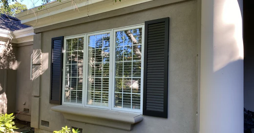 double mulled windows with exterior shutters